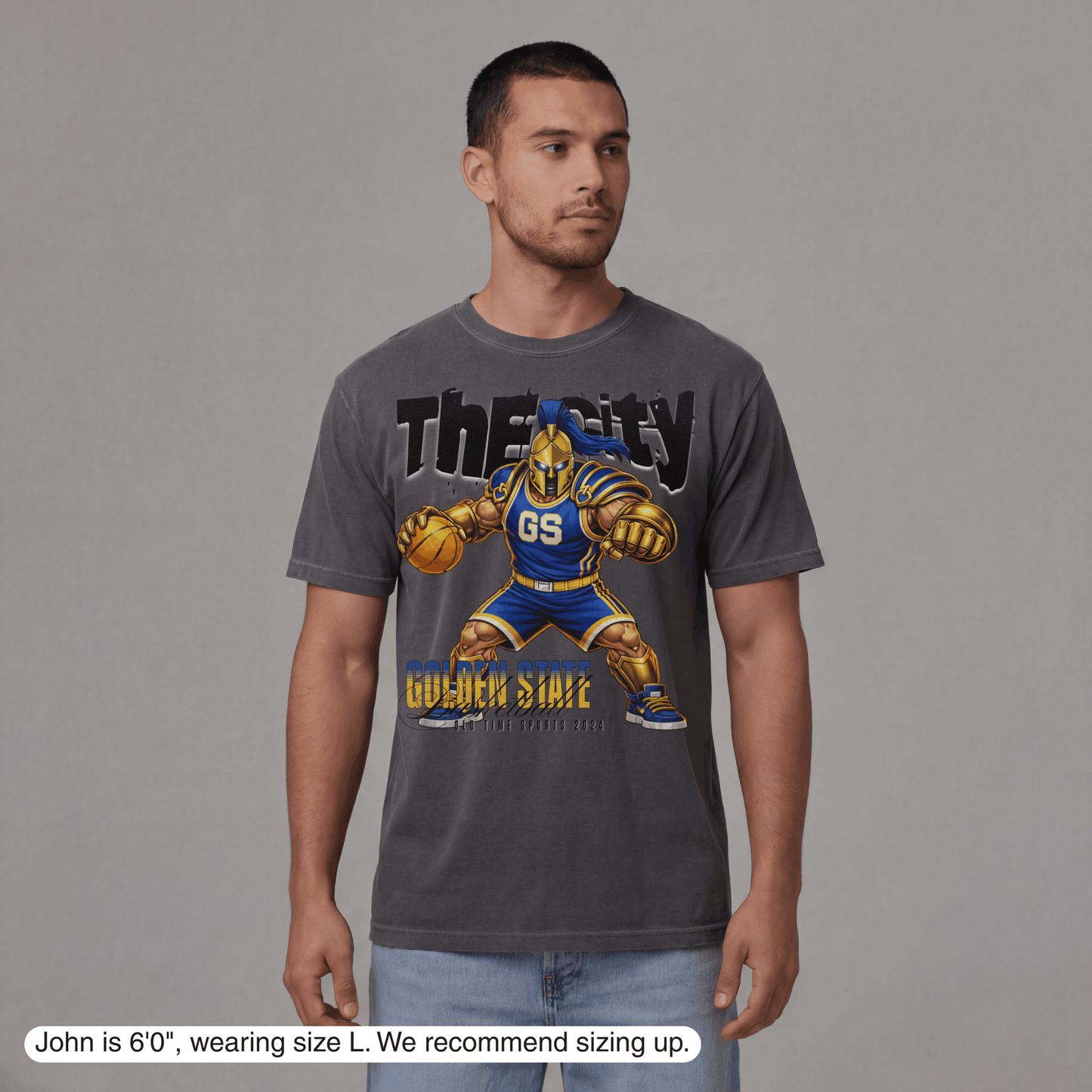 Man wearing a gray t-shirt with a graphic design on a gray background