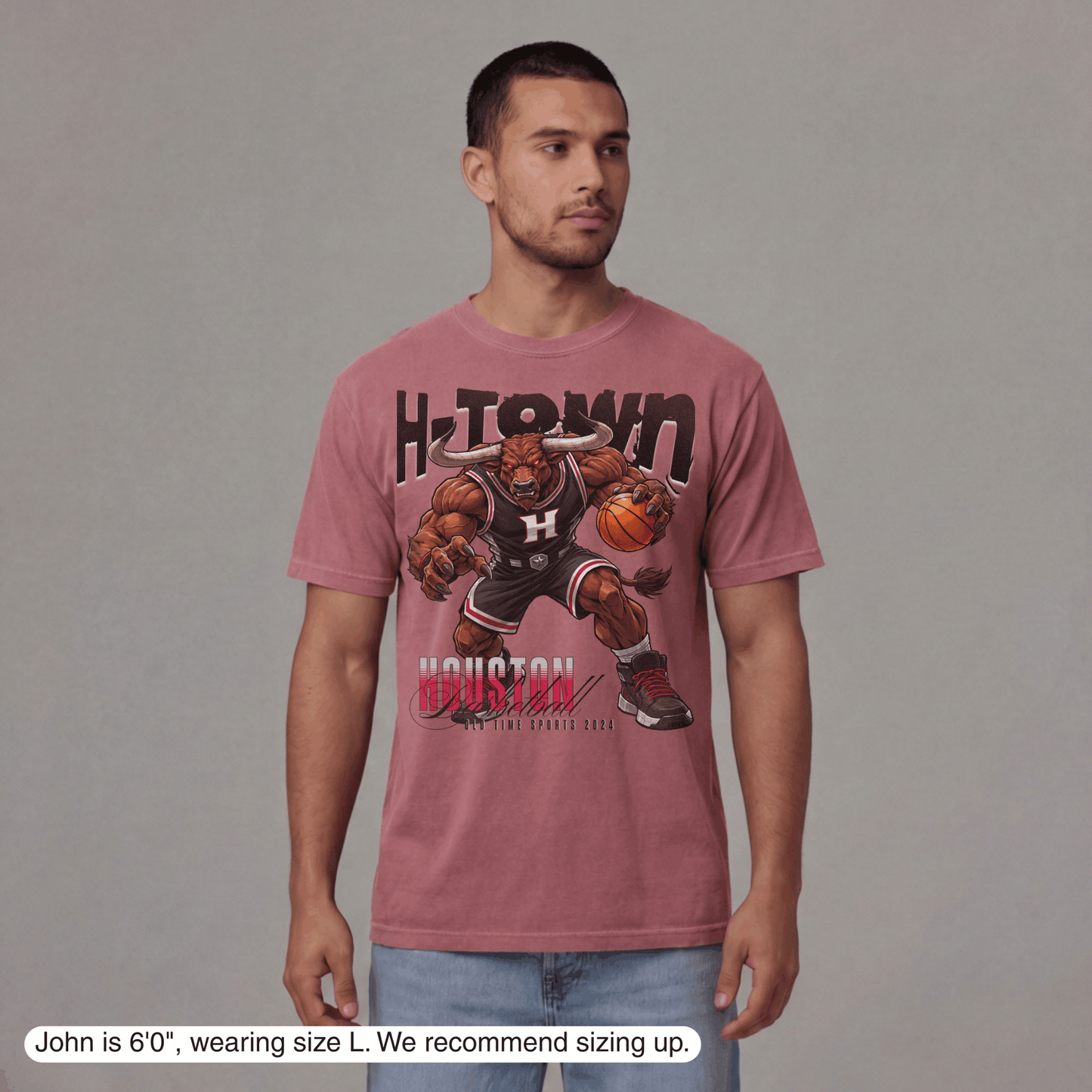 Man wearing a pink t-shirt with a graphic design on a gray background