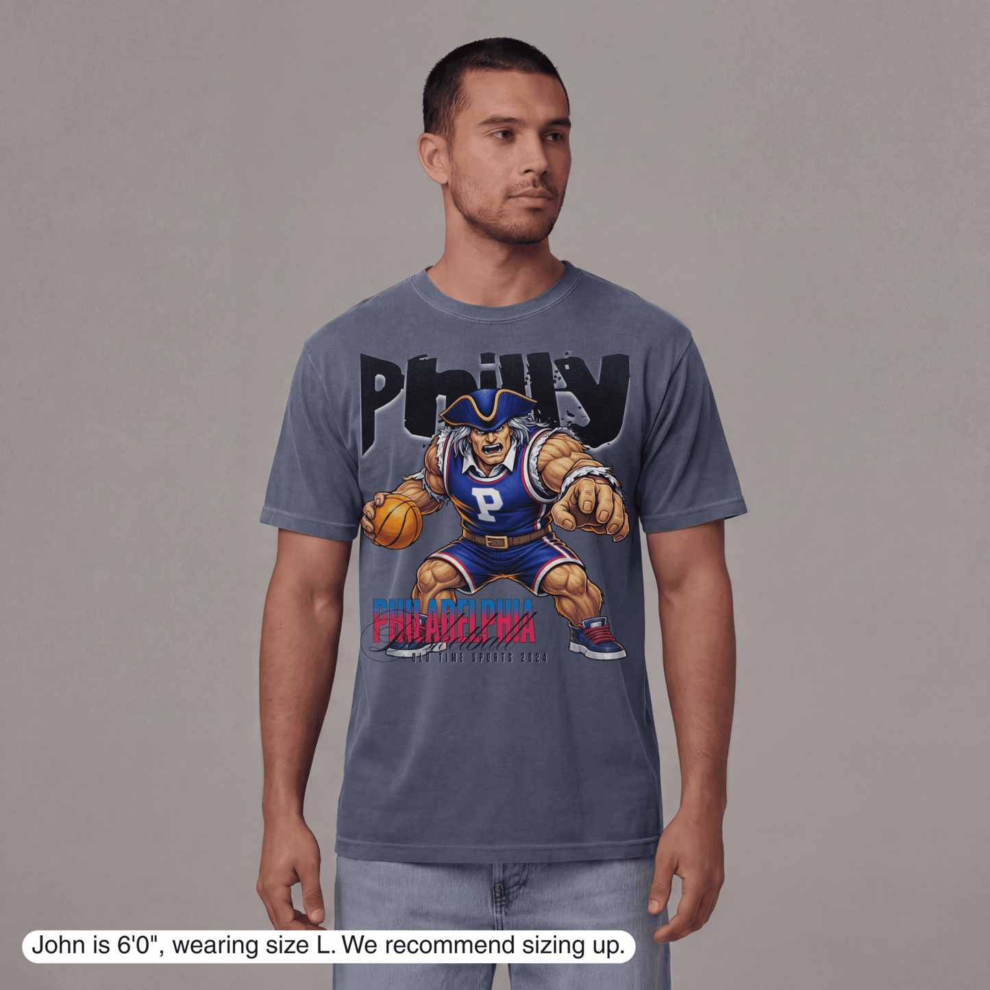 Man wearing a gray t-shirt with a graphic design on a plain background