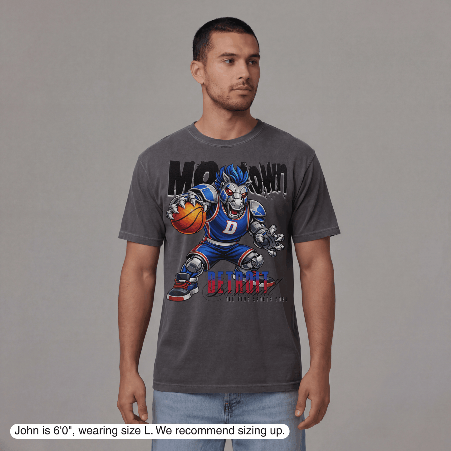 Man wearing a gray t-shirt with a graphic design on a plain background