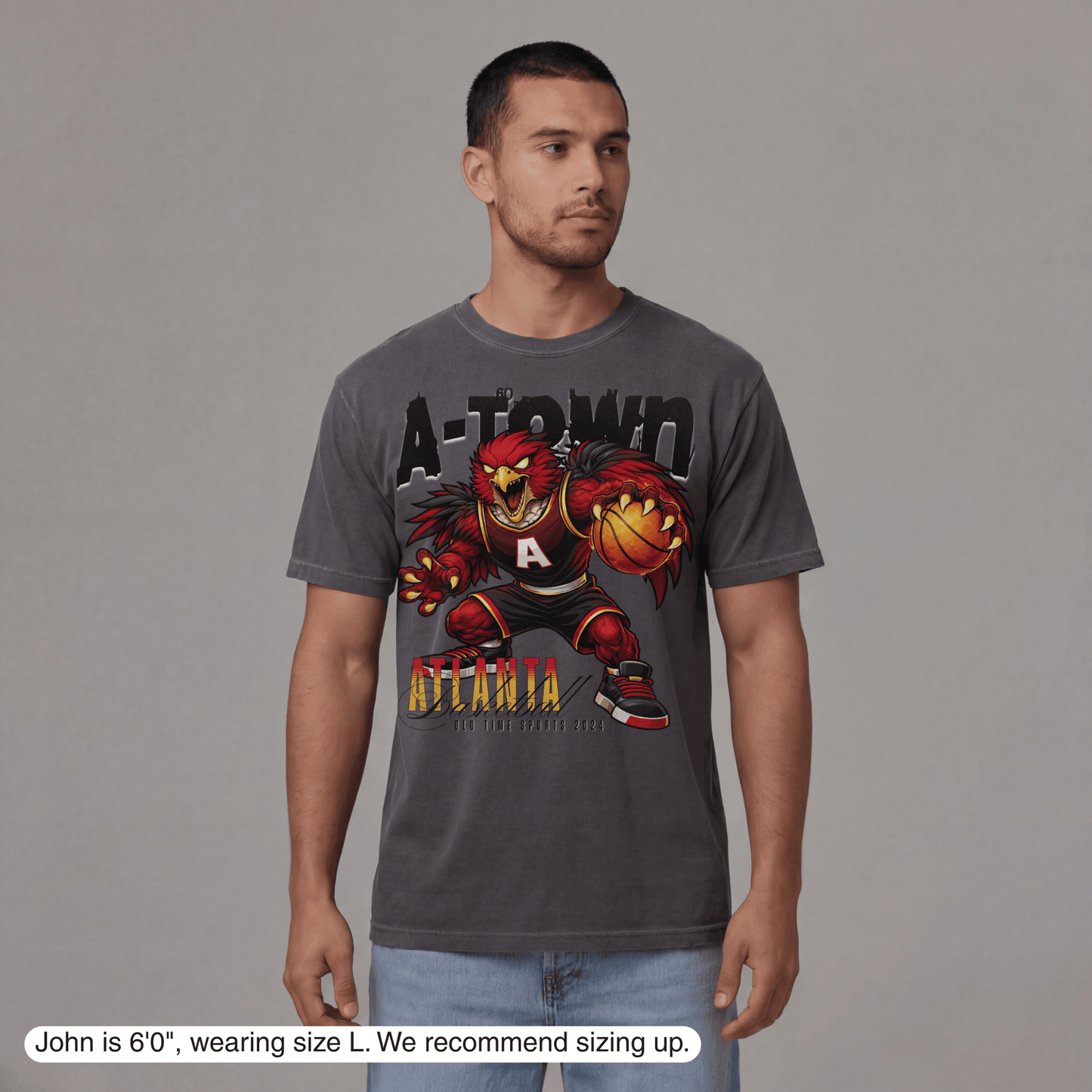 Man wearing a gray t-shirt with a graphic design on a gray background