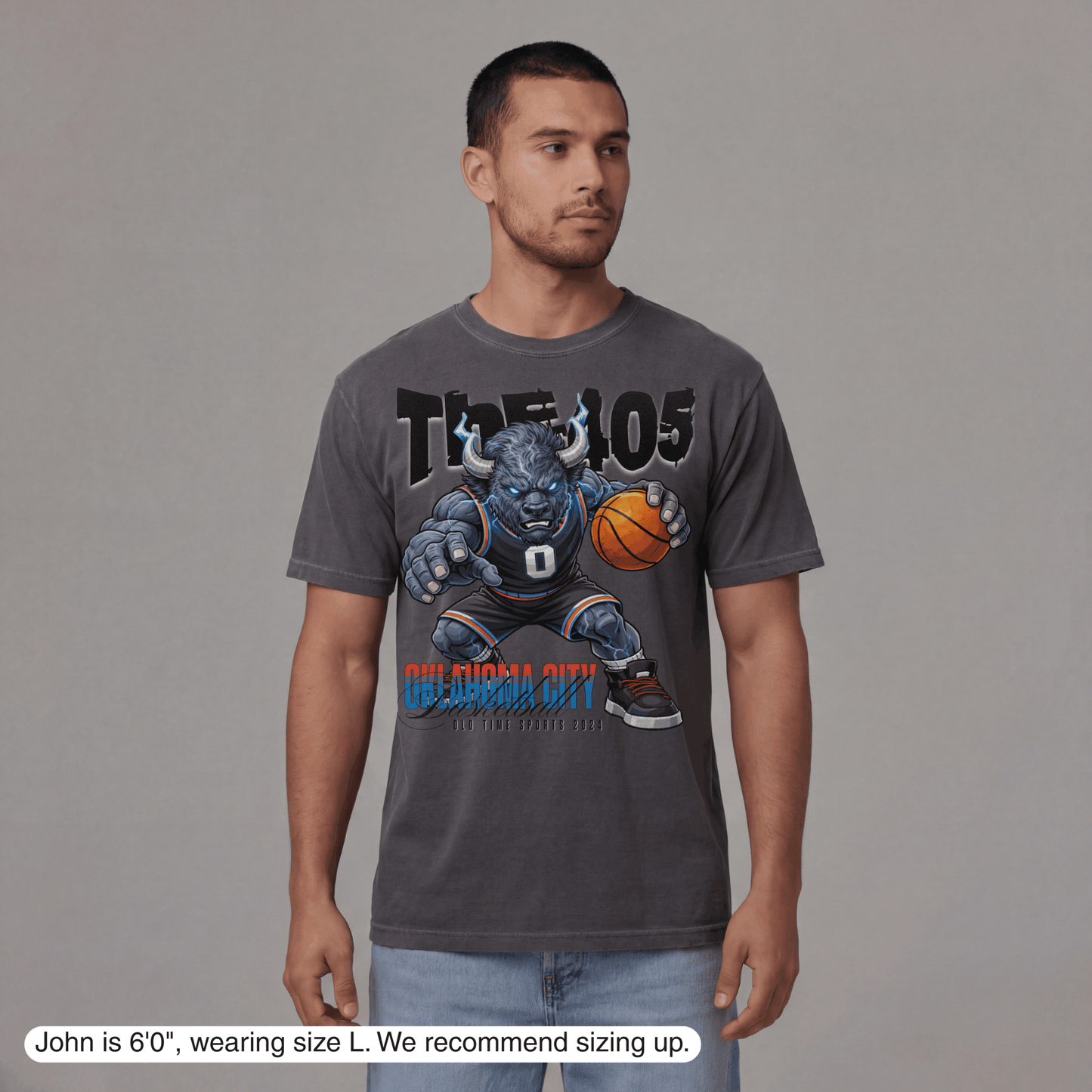 Man wearing a gray t-shirt with a graphic design on a gray background