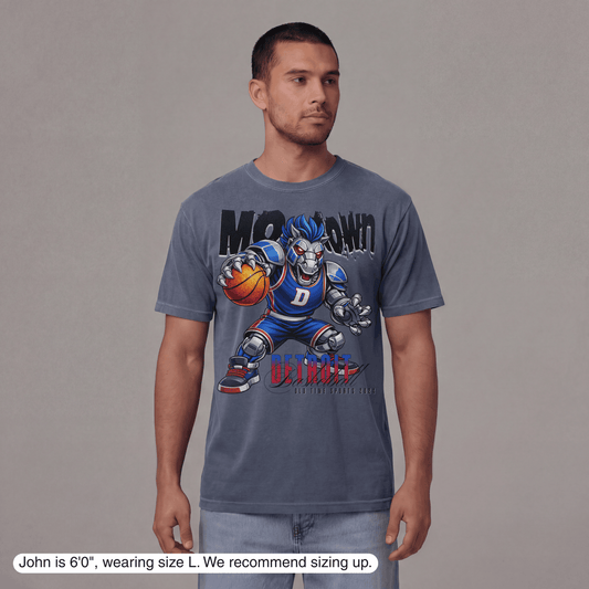 Man wearing a blue t-shirt with a graphic design on a gray background