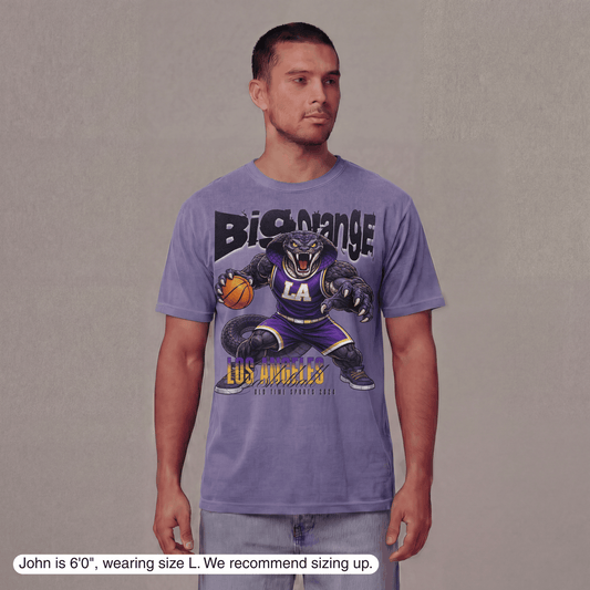 Man wearing a purple t-shirt with a graphic design on a plain background