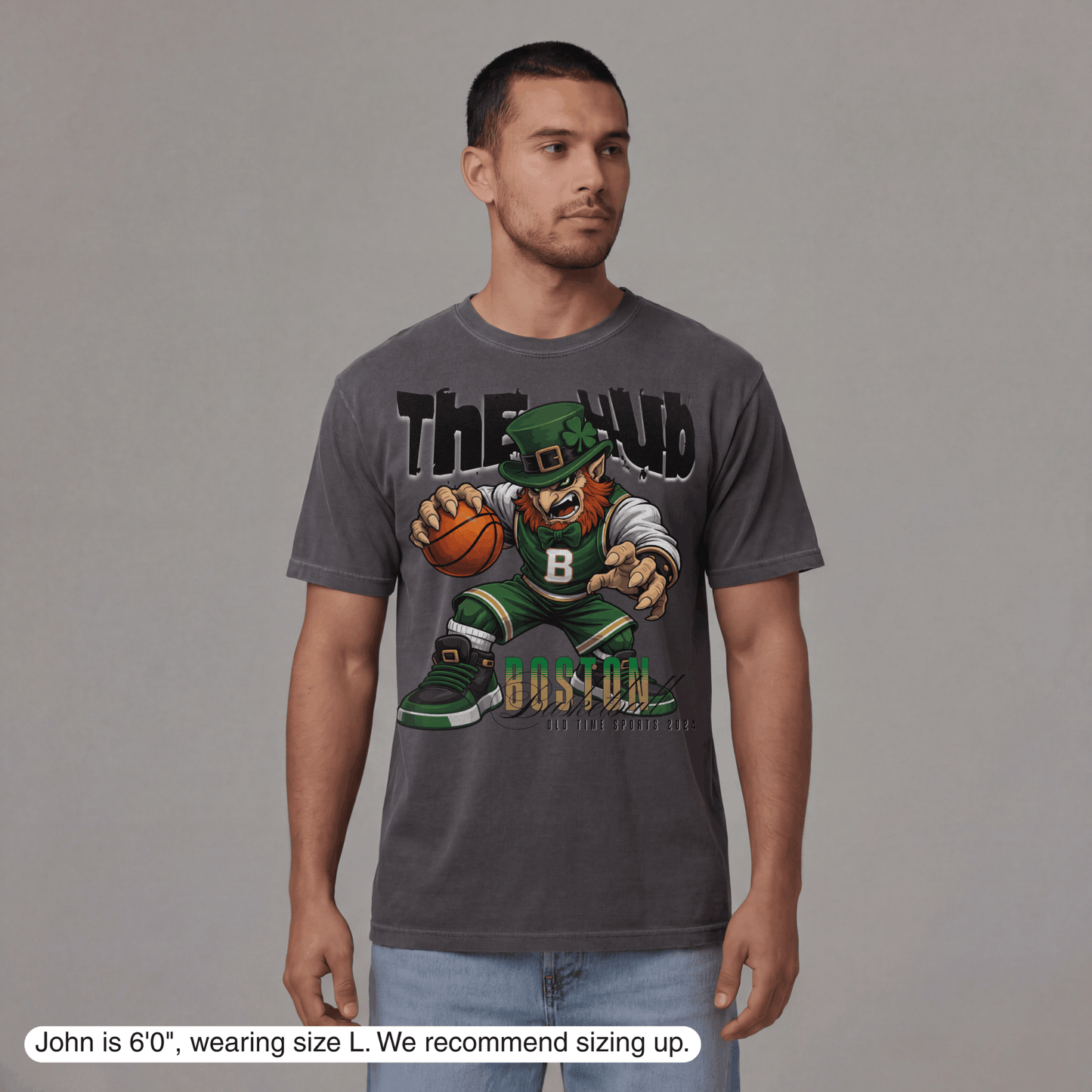 Man wearing a gray t-shirt with a graphic design on a plain background