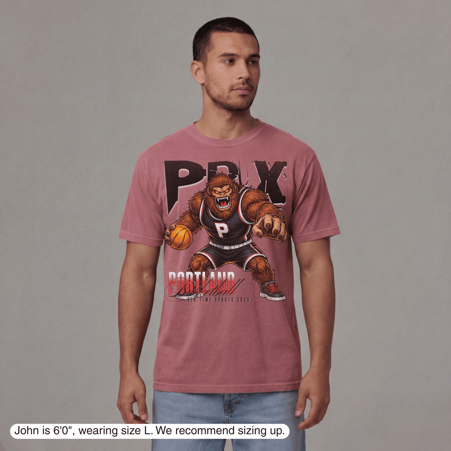 Man wearing a pink t-shirt with a graphic design on a gray background