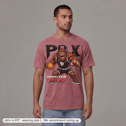 Man wearing a pink t-shirt with a graphic design on a gray background