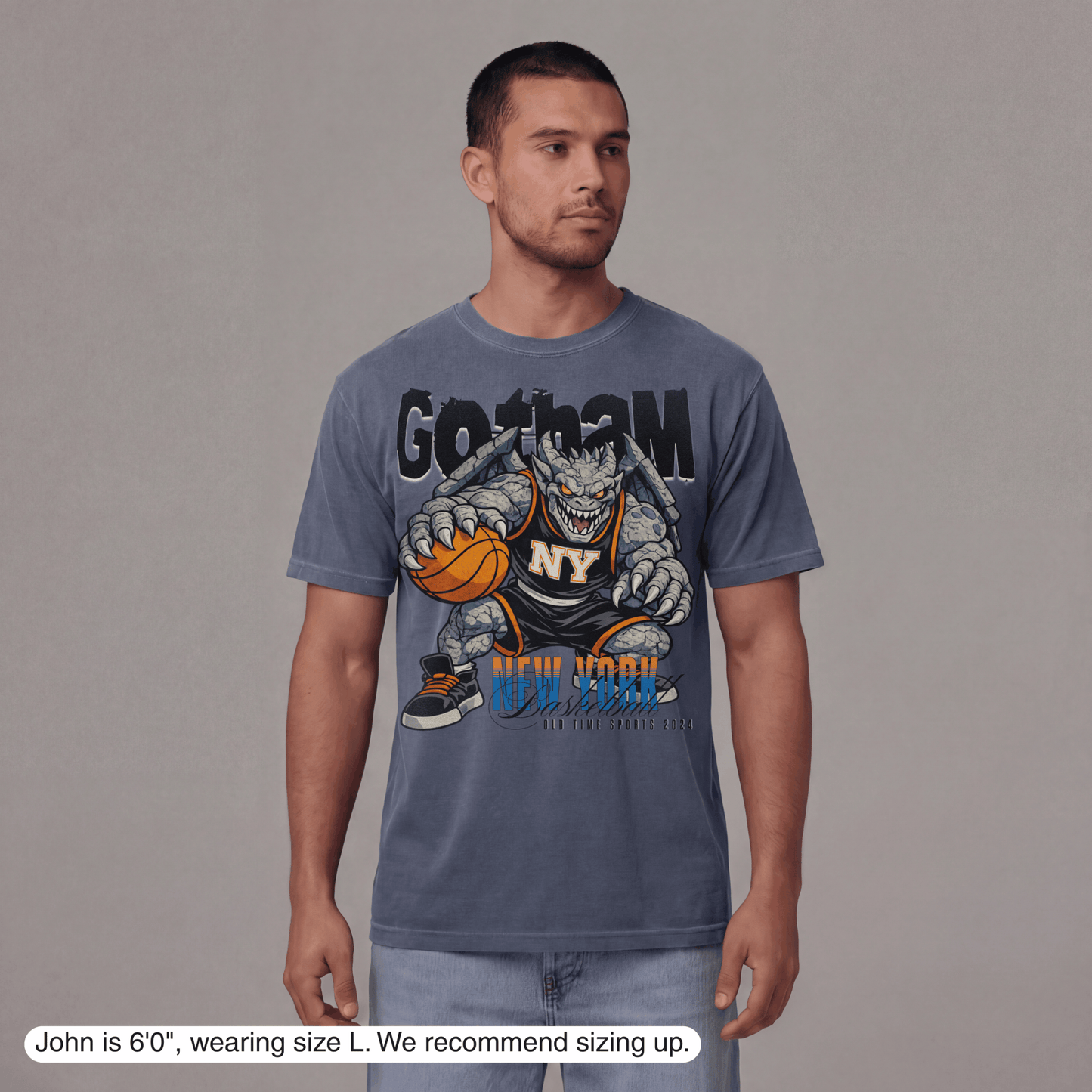 Man wearing a blue t-shirt with a graphic design on a gray background