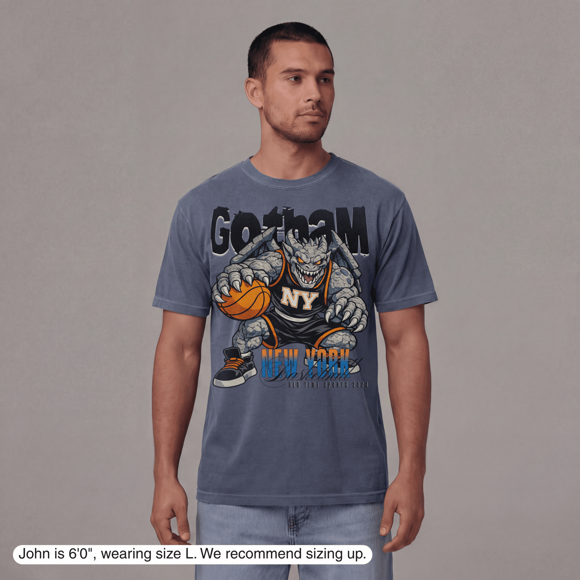 Man wearing a blue t-shirt with a graphic design on a gray background