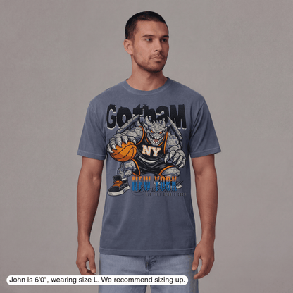 Man wearing a blue t-shirt with a graphic design on a gray background