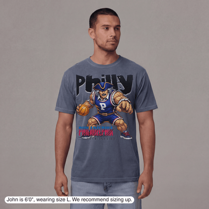 Man wearing a gray t-shirt with a graphic design on a plain background