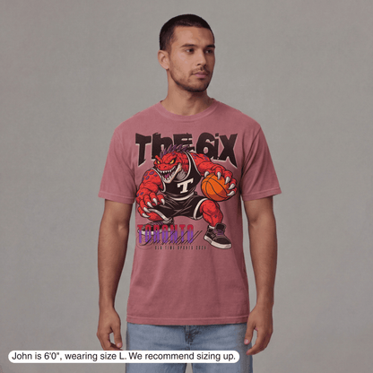 Man wearing a maroon t-shirt with a graphic design on a gray background