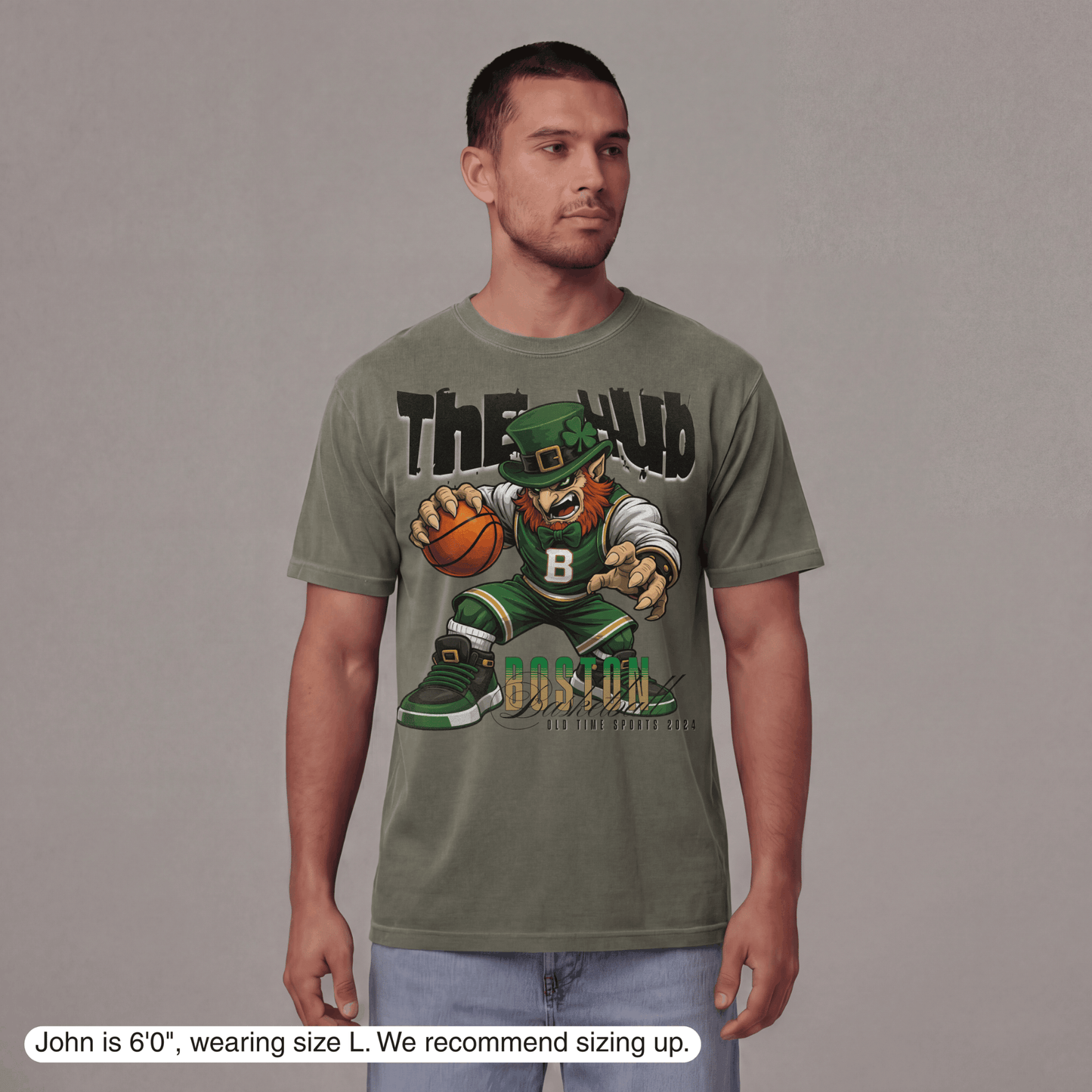 Man wearing a green t-shirt with a graphic design on a gray background