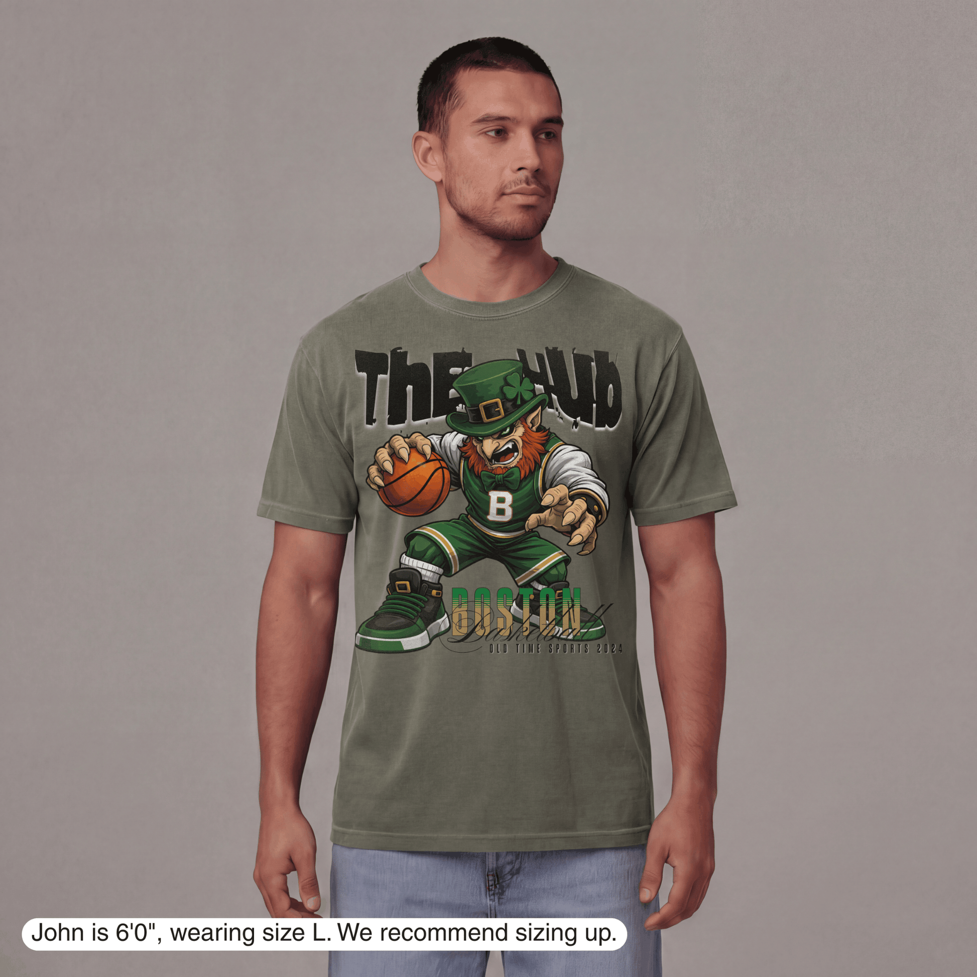 Man wearing a green t-shirt with a graphic design on a gray background