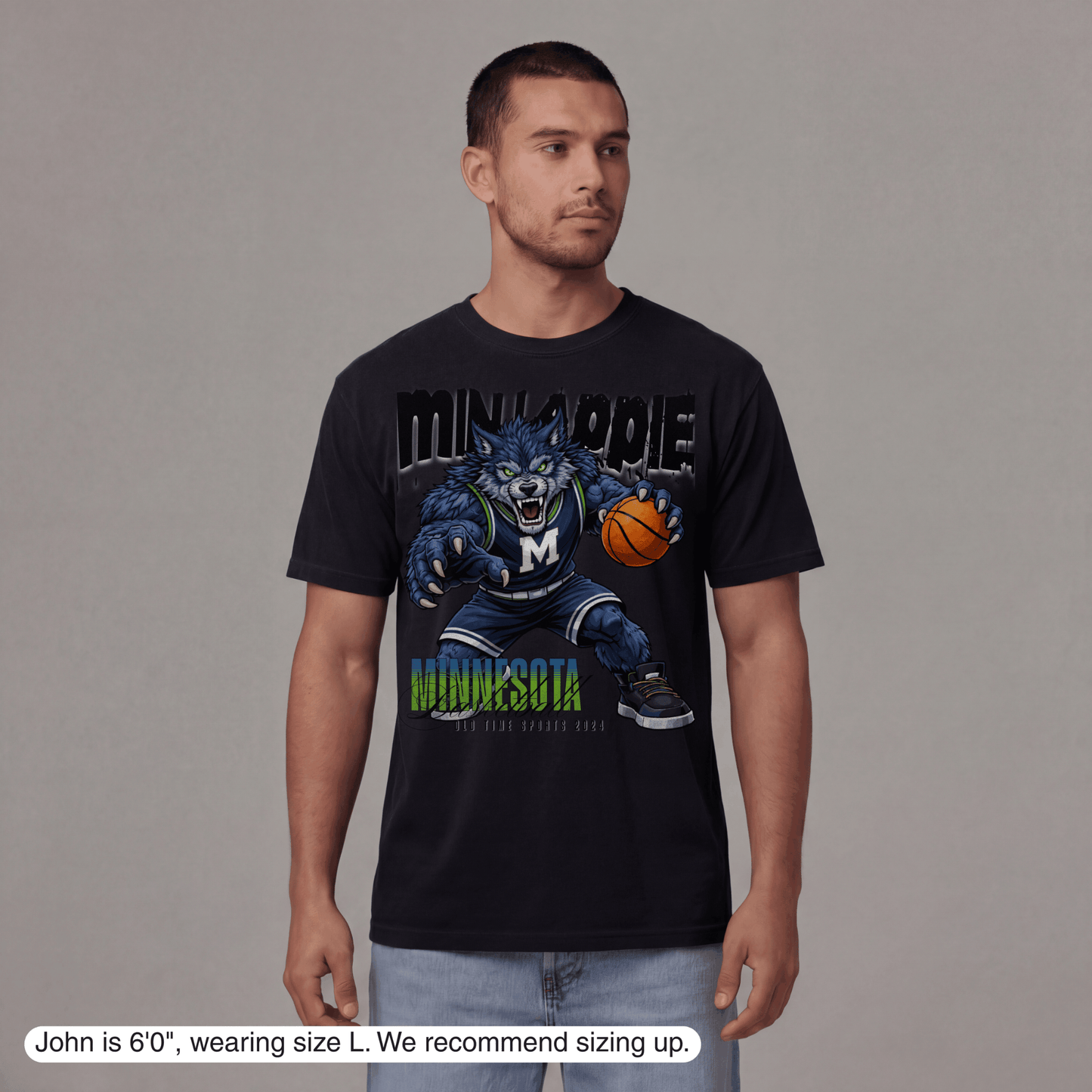 Man wearing a black t-shirt with a graphic design on a gray background