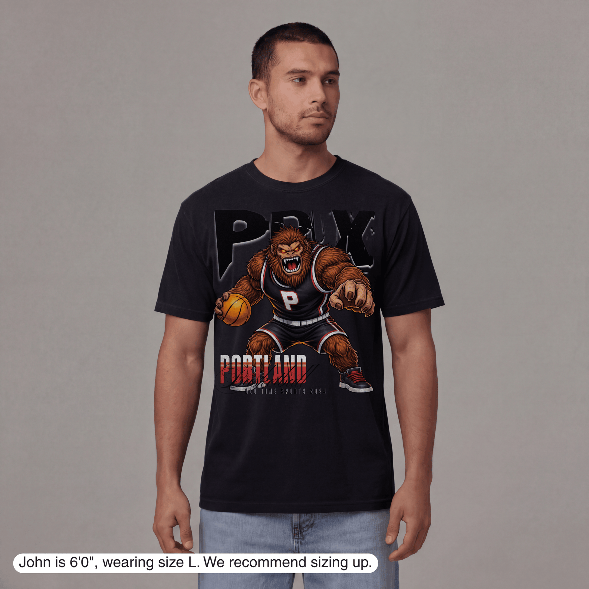 Man wearing a black t-shirt with a graphic design on a gray background