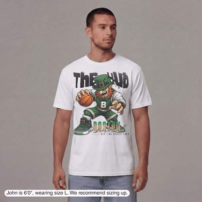 Man wearing a white t-shirt with a graphic design of a leprechaun holding a basketball, with text 'The Hub' and 'Boston' on a gray background.
