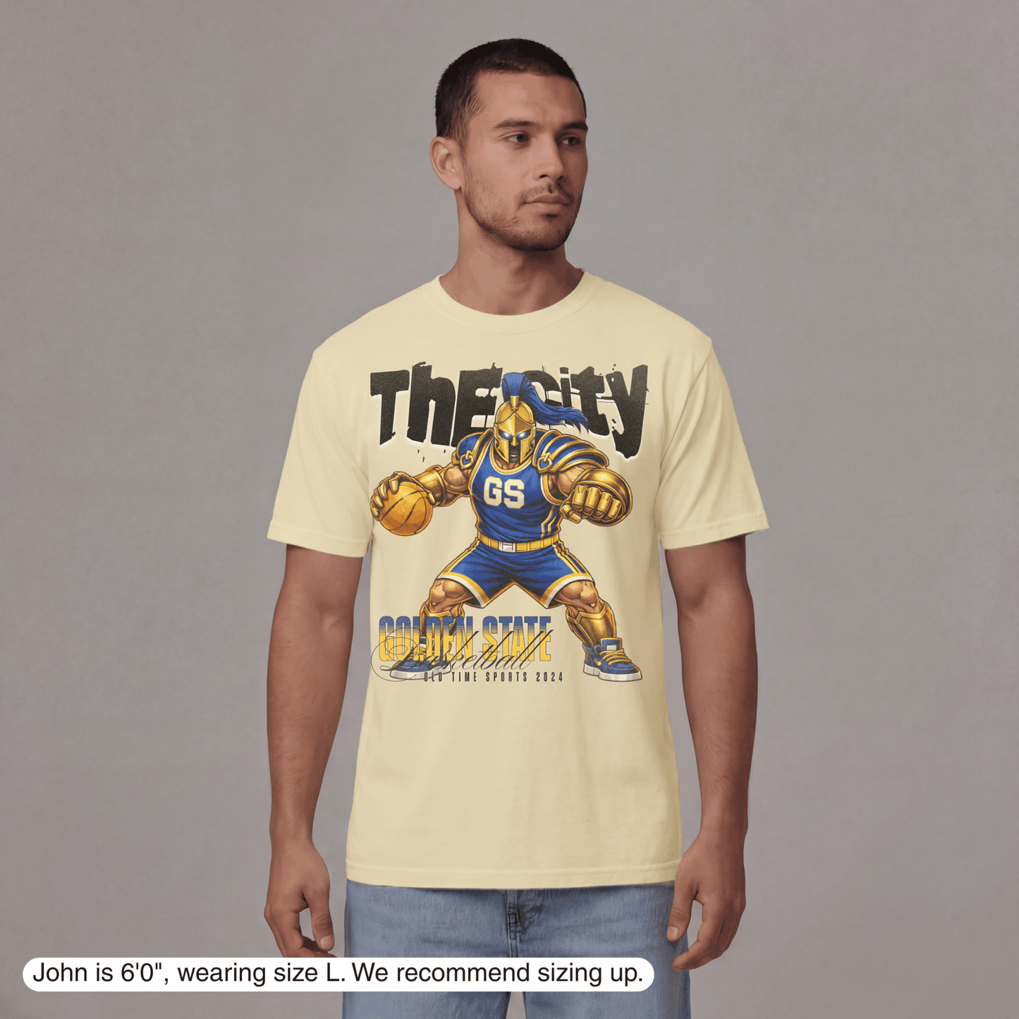 Man wearing a yellow t-shirt with a graphic design on a gray background