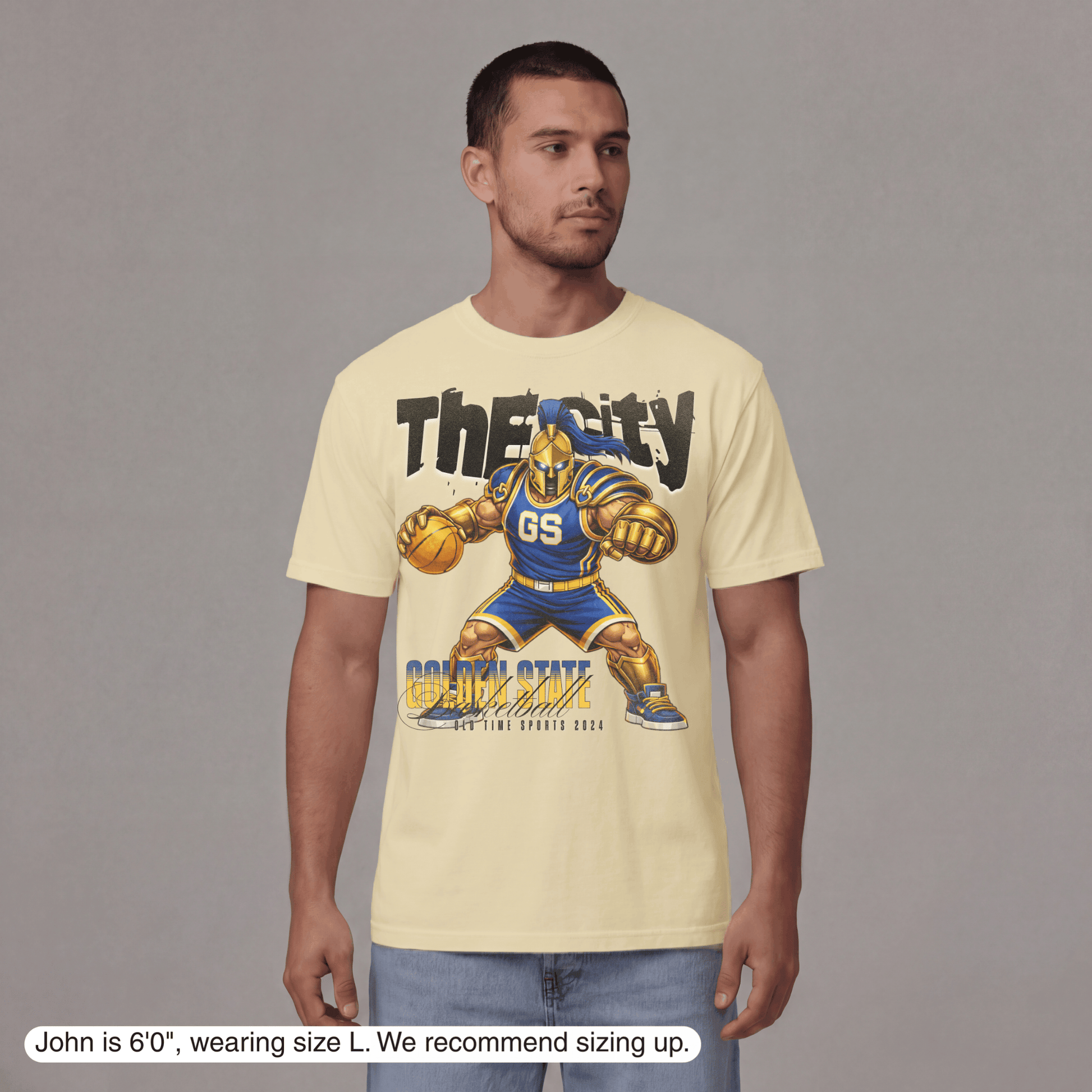 Man wearing a yellow t-shirt with a graphic design on a gray background