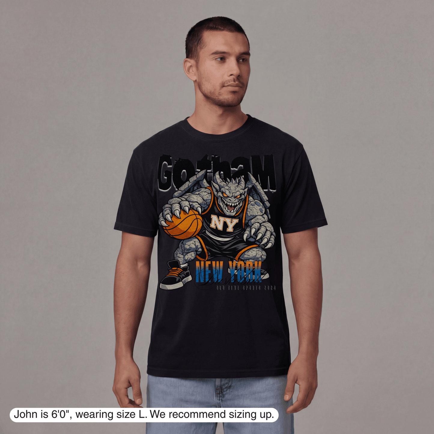 Man wearing a black t-shirt with a graphic design on a gray background