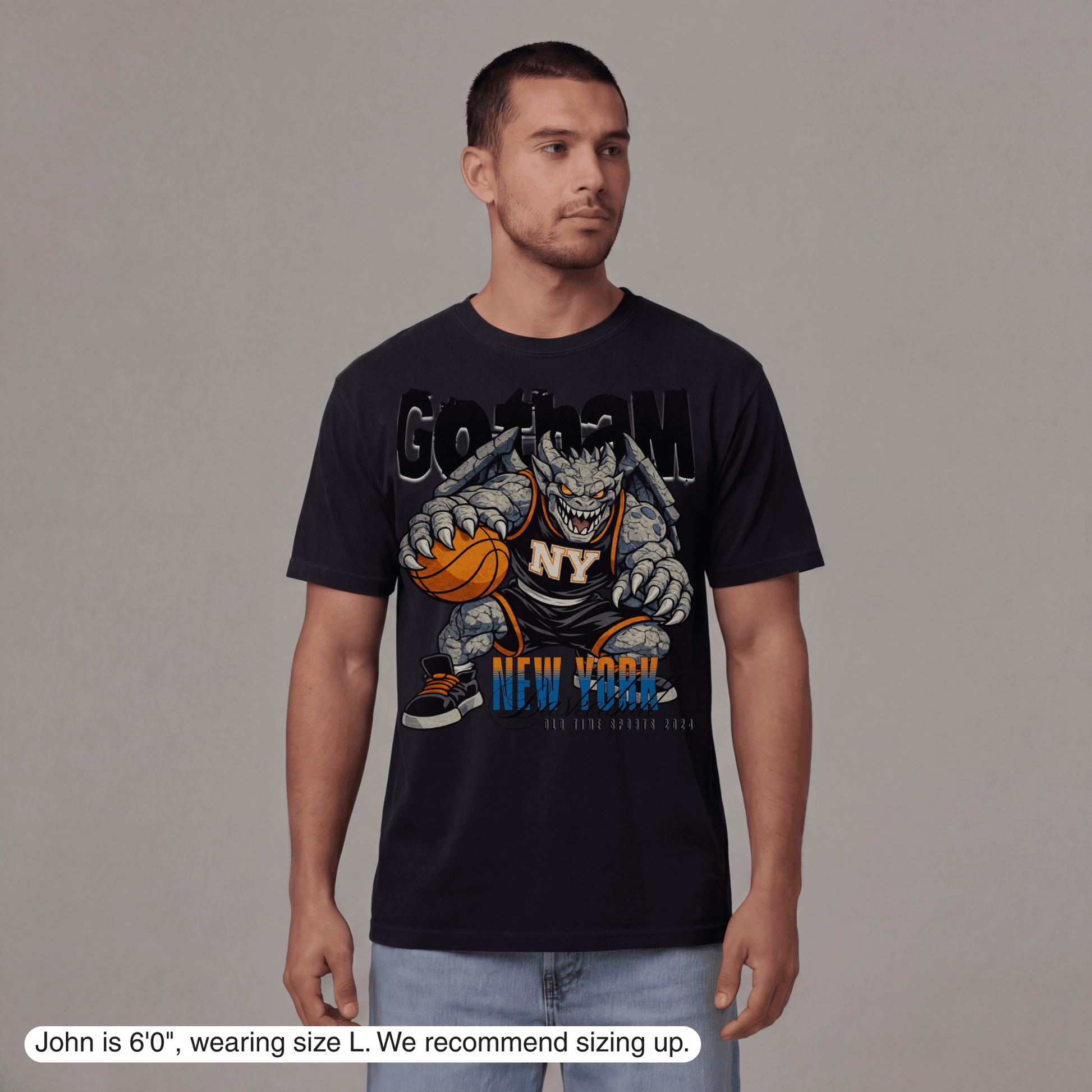 Man wearing a black t-shirt with a graphic design on a gray background