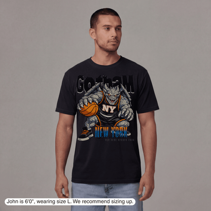 Man wearing a black t-shirt with a graphic design on a gray background