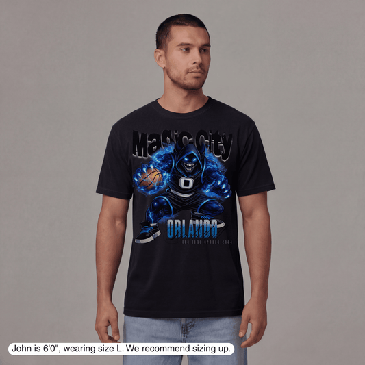 Man wearing a black t-shirt with a graphic design on a gray background