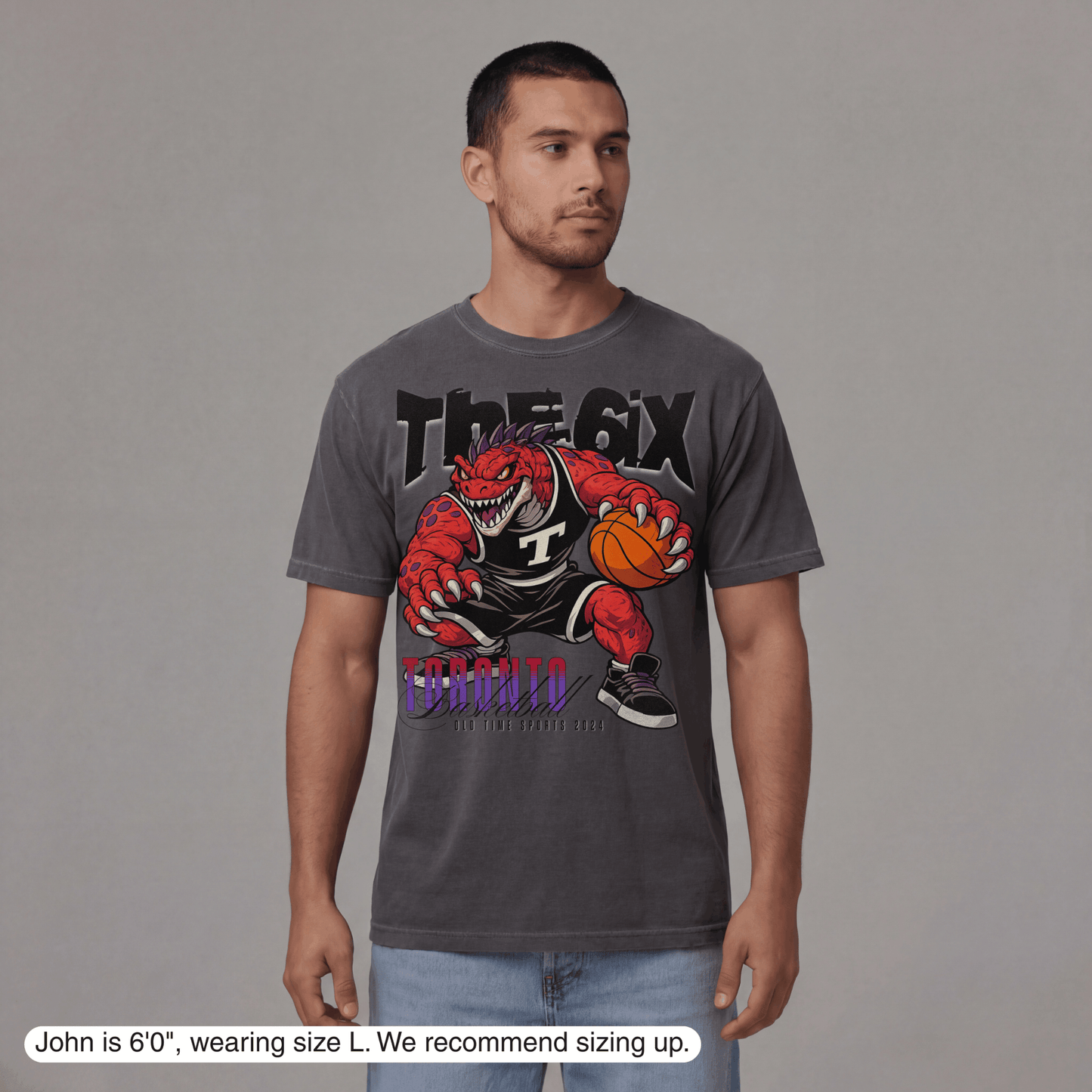 Man wearing a gray t-shirt with a graphic design on a gray background