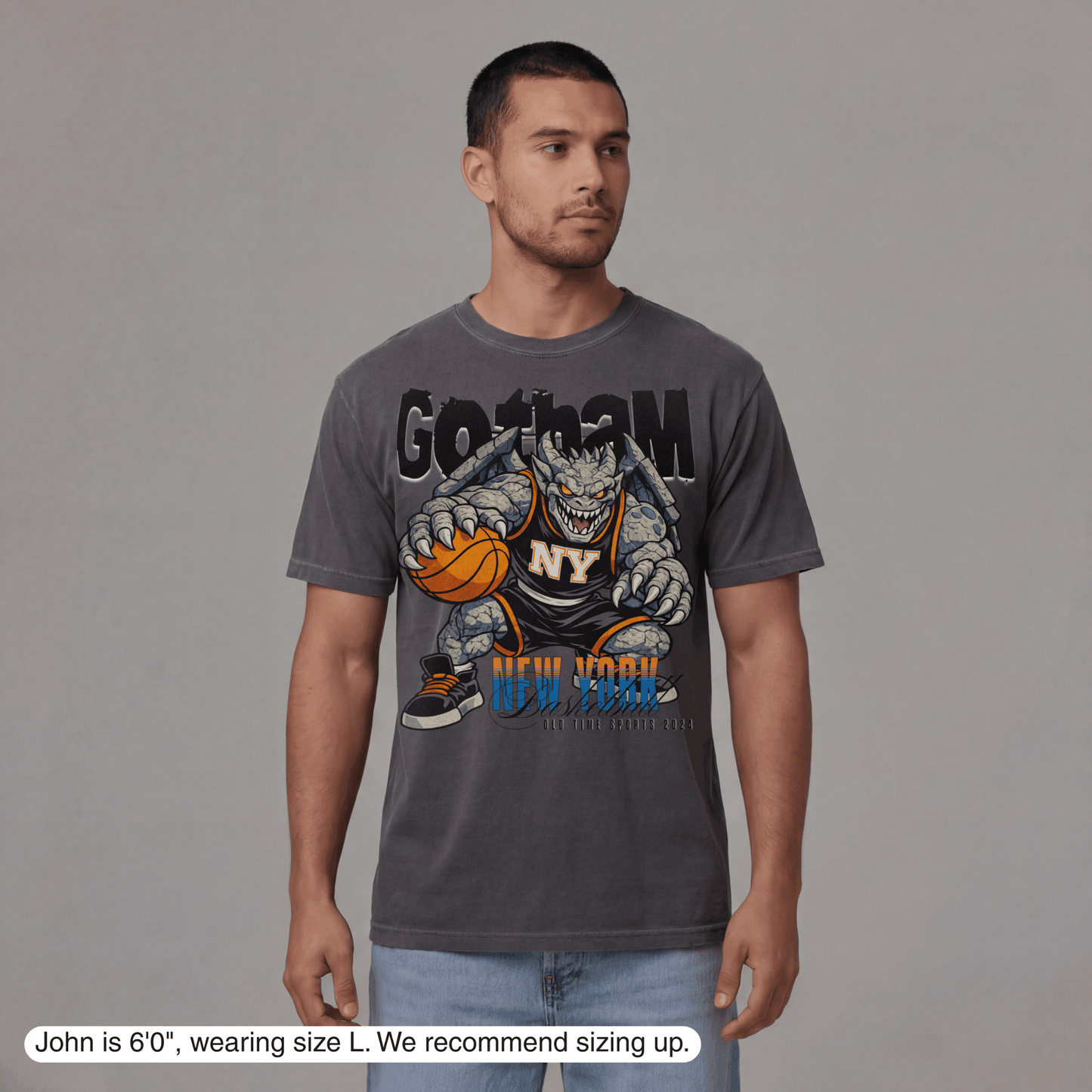 Man wearing a gray t-shirt with a graphic design on a plain background