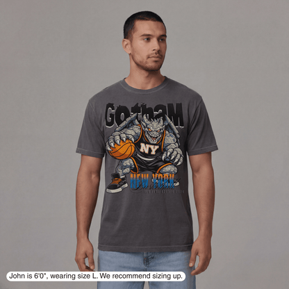 Man wearing a gray t-shirt with a graphic design on a plain background