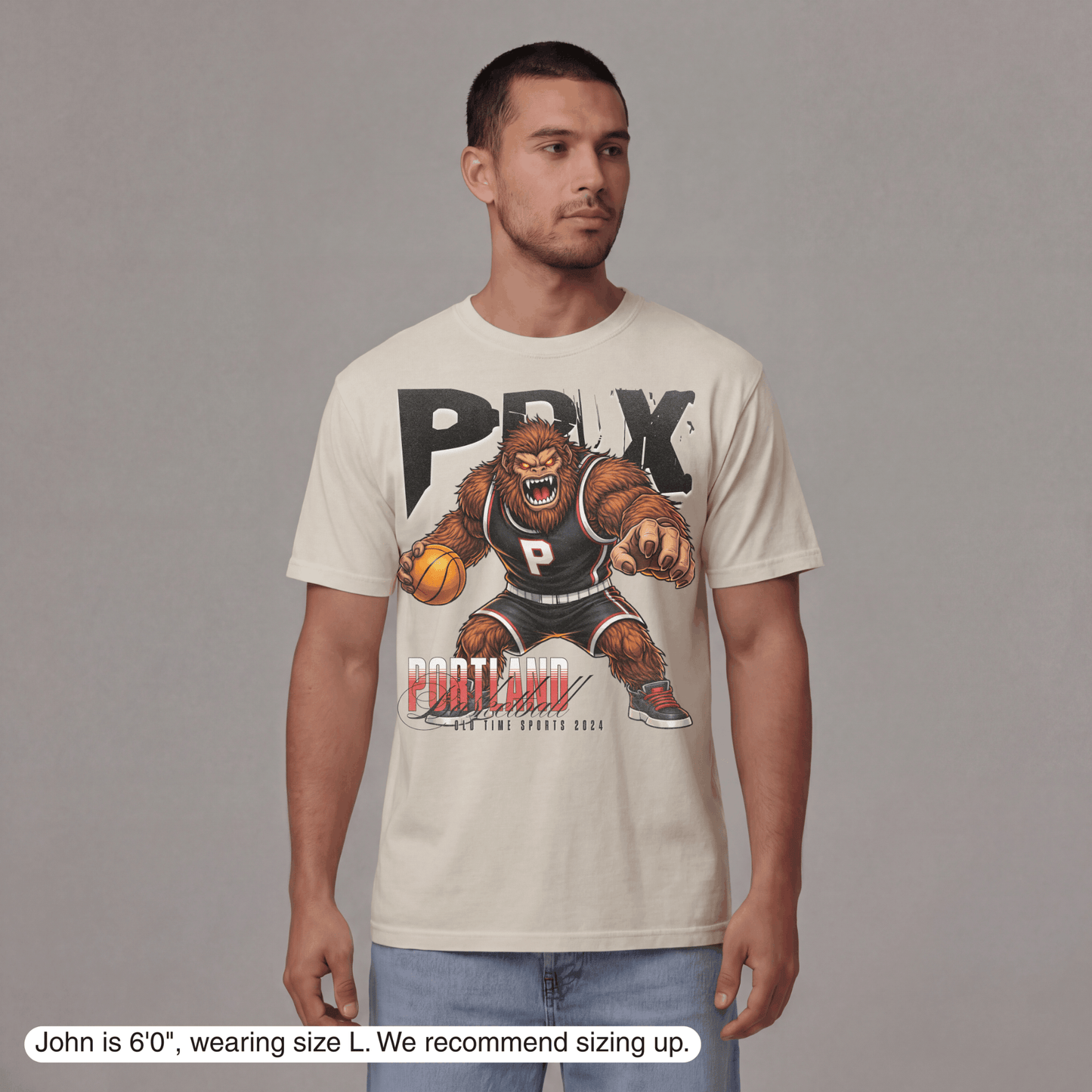 Man wearing a t-shirt with a graphic design on a gray background