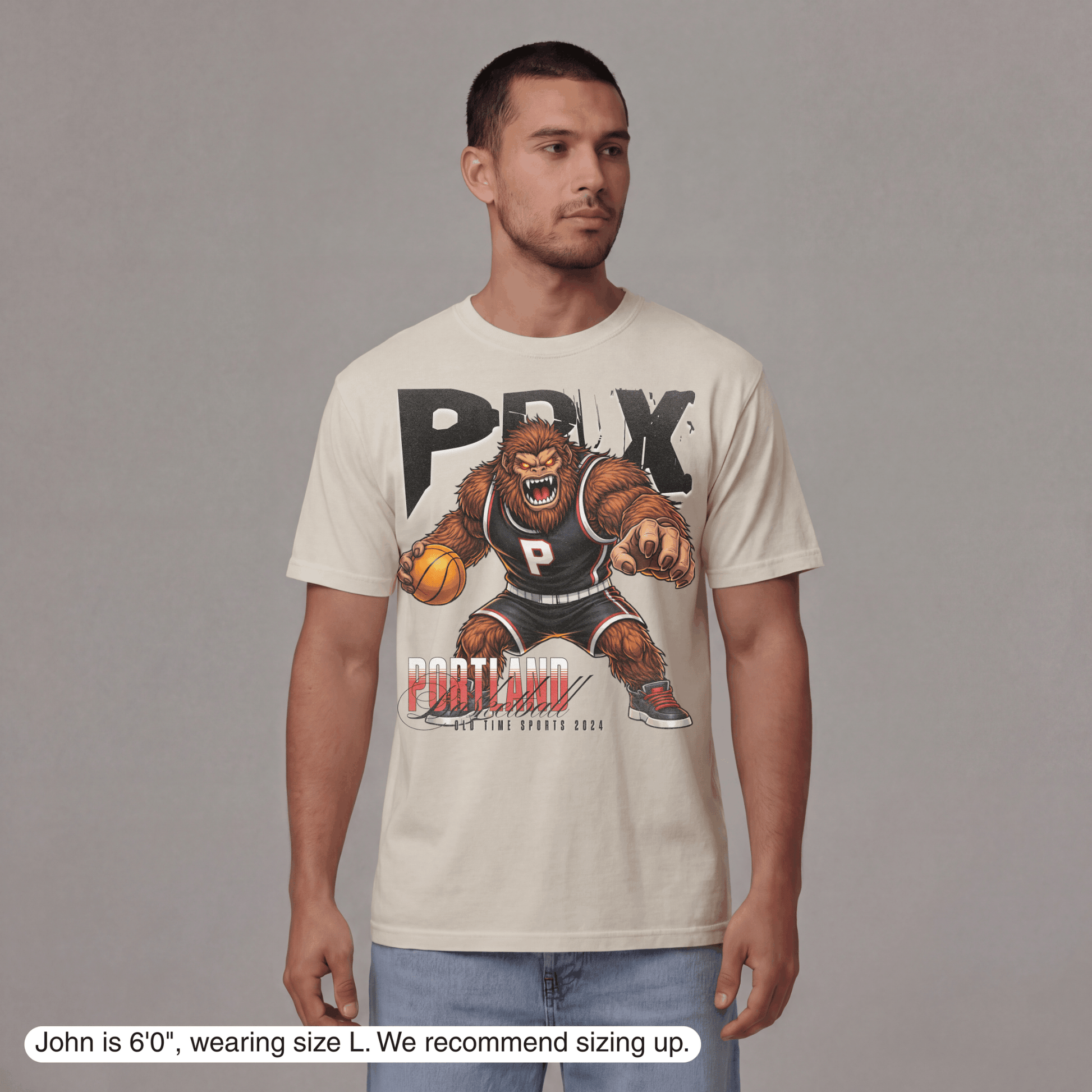 Man wearing a t-shirt with a graphic design on a gray background