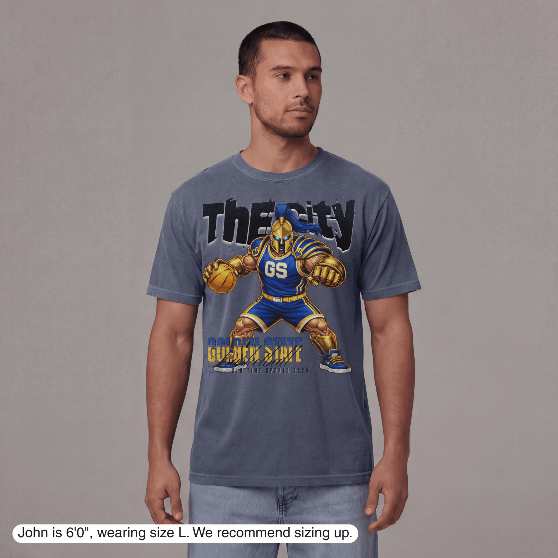 Man wearing a blue t-shirt with a graphic design on a gray background