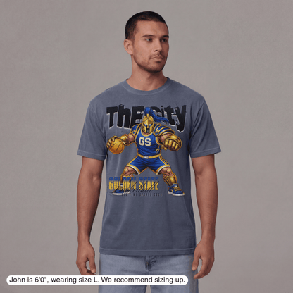 Man wearing a blue t-shirt with a graphic design on a gray background