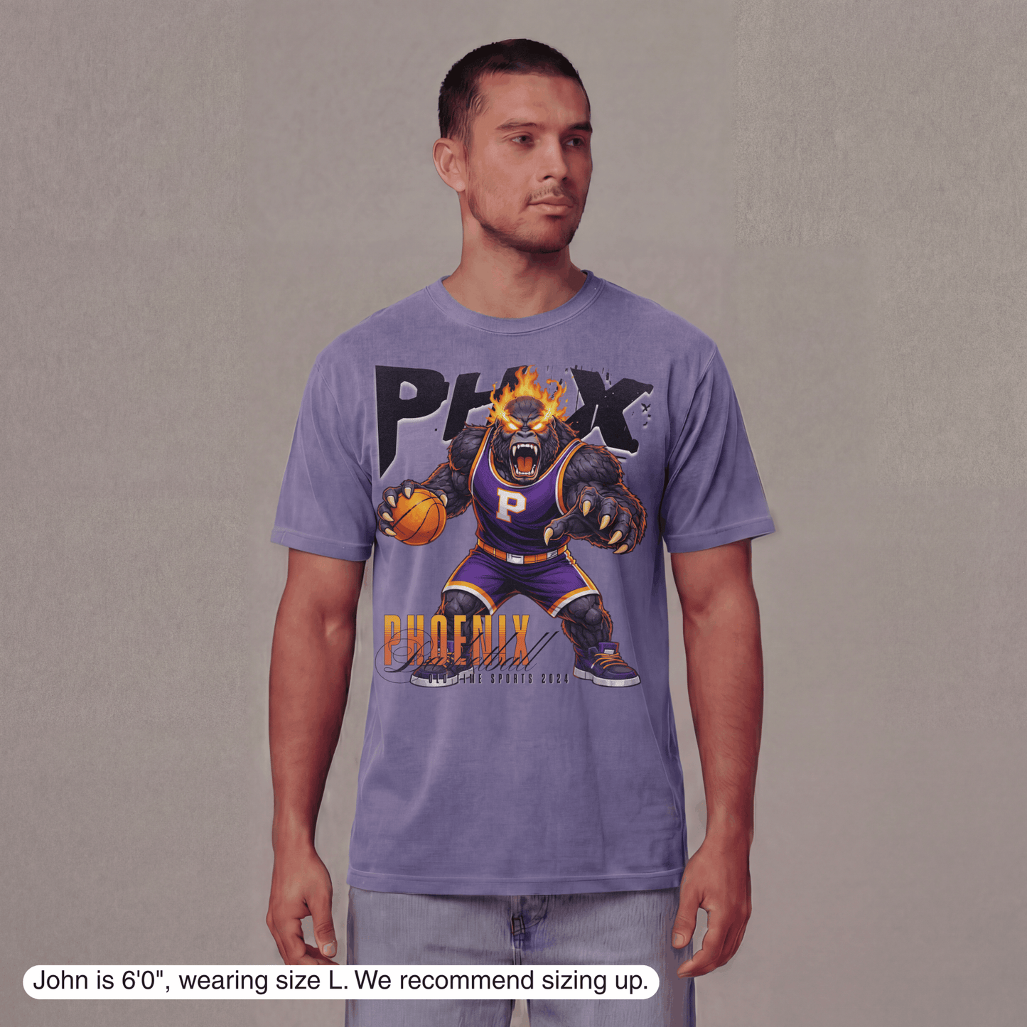 Man wearing a purple t-shirt with a graphic design on a plain background