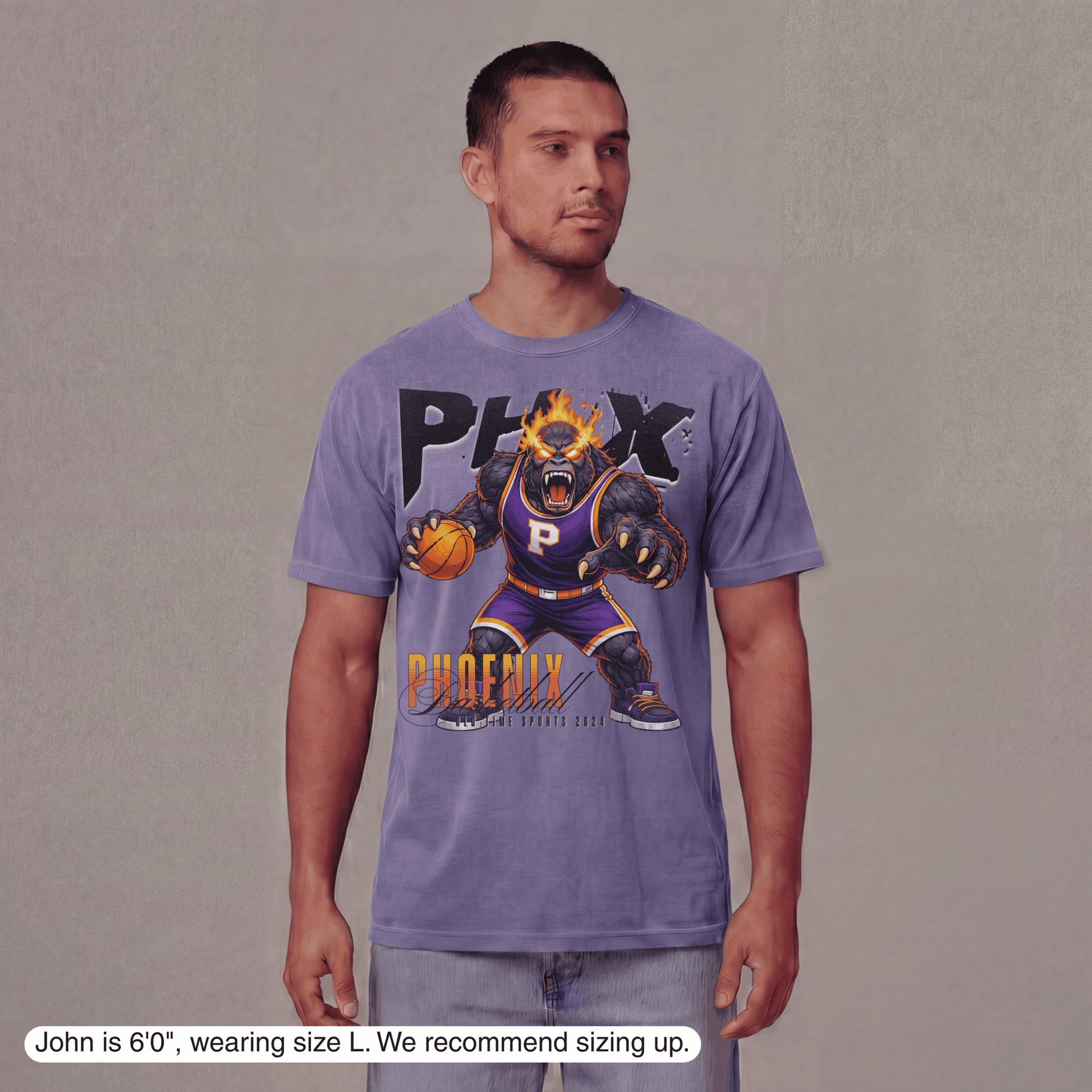 Man wearing a purple t-shirt with a graphic design on a plain background