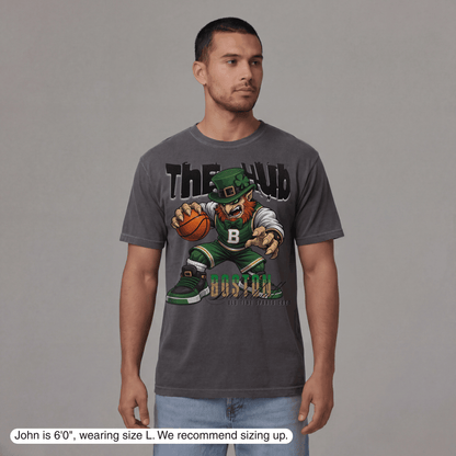 Man wearing a gray t-shirt with a graphic design on a plain background