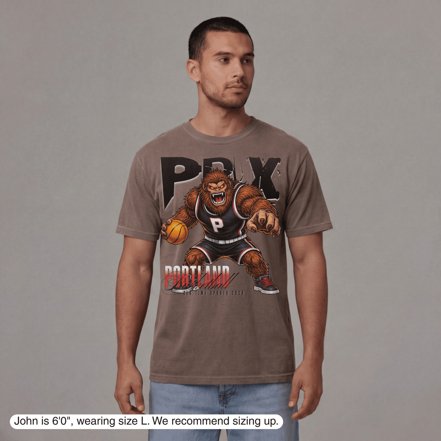 Man wearing a t-shirt with a graphic design on a gray background