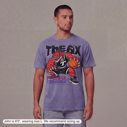 Man wearing a purple t-shirt with a graphic design on a plain background